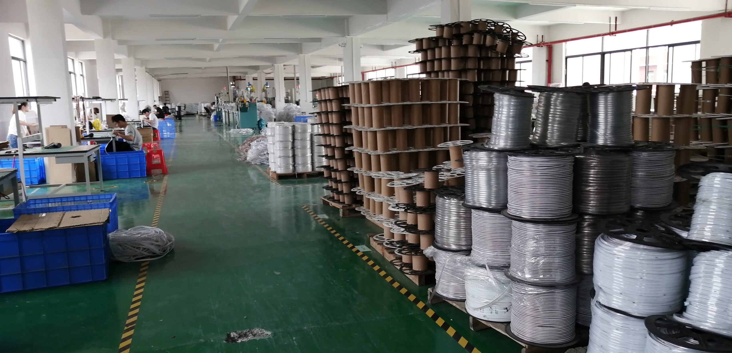 LED processing workshop area filled with various reels and rolls of flexible PCB substrate and raw LED materials.