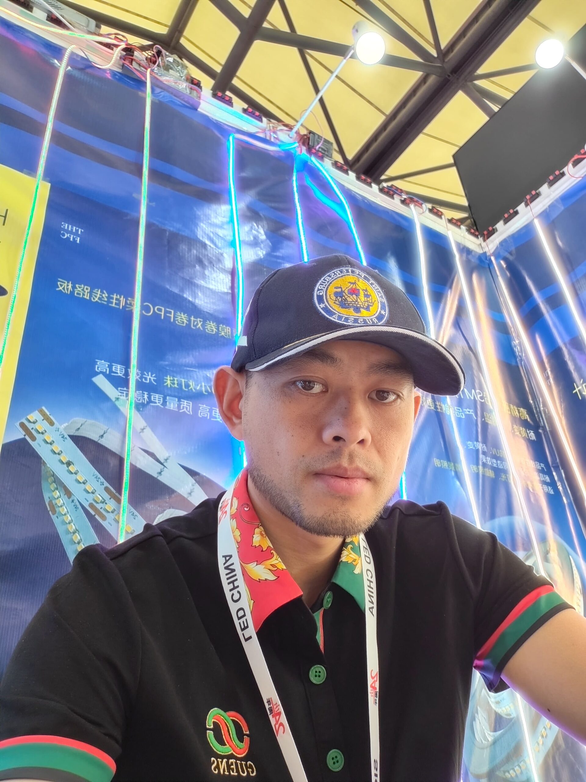 Professional sales representative at lighting exhibition booth, showcasing various high-density LED strip products.